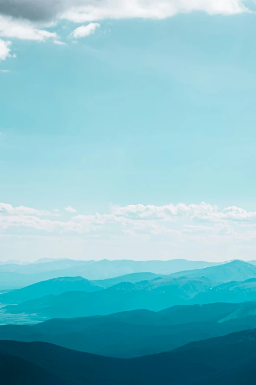 a hill covered in blue clouds and water