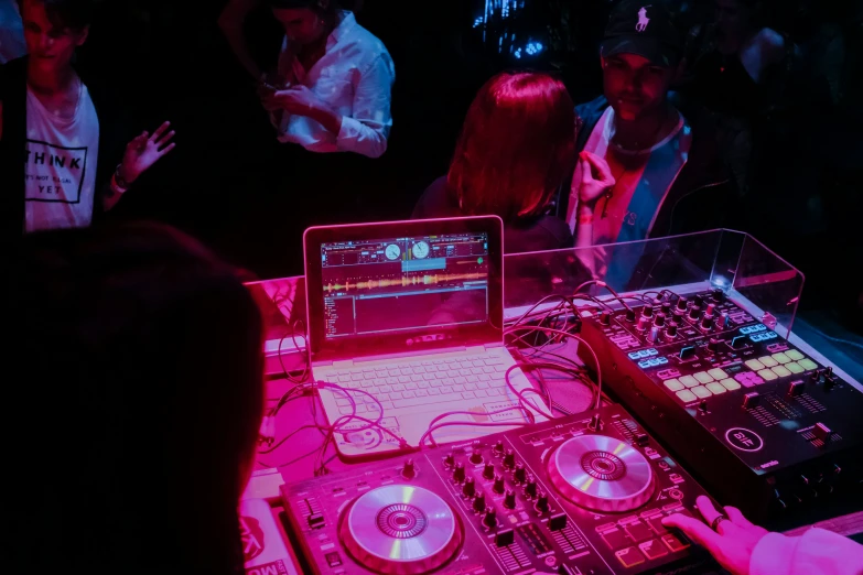 dj's and his mixing desk at a party