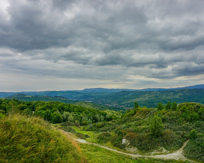 a view of the mountains and valleys in a cloudy sky