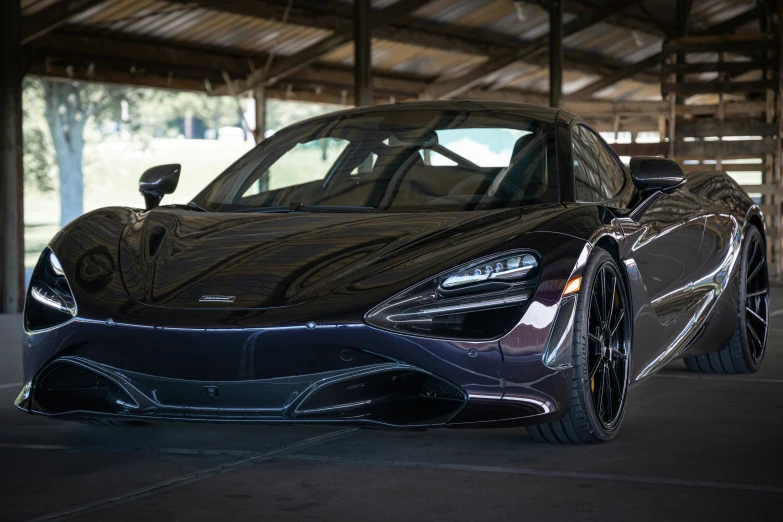 a black sport car sits in an open area