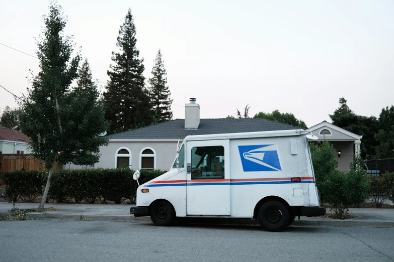 an email truck with a letter sitting in front