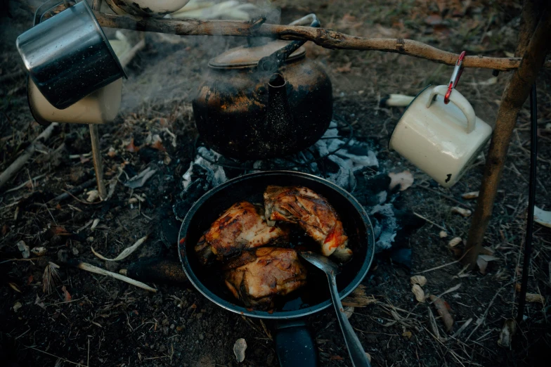several foods cooking on top of a camp stove