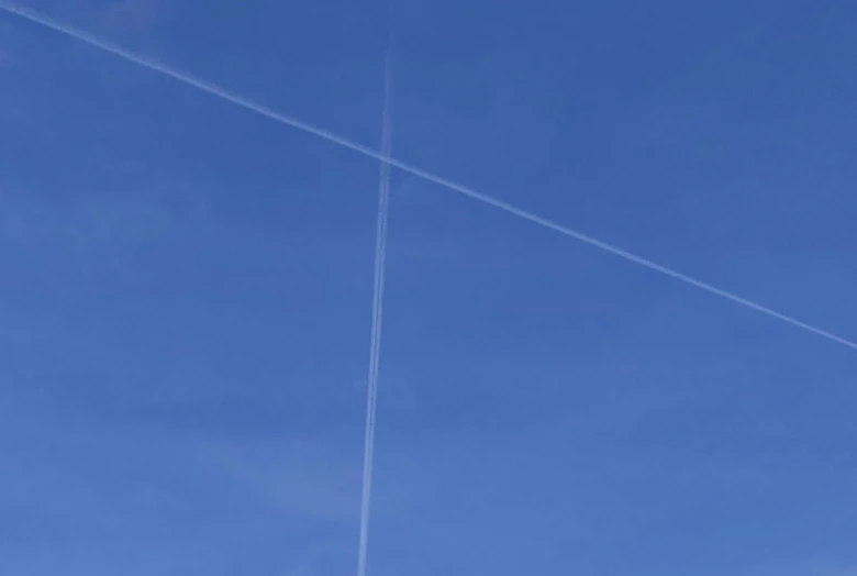 two airplanes are flying in the sky together