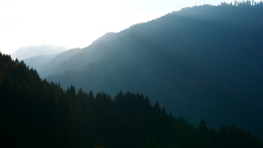 a mountain side is shown with several trees and mountains