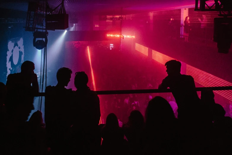 the silhouettes of people are in front of bright red lights