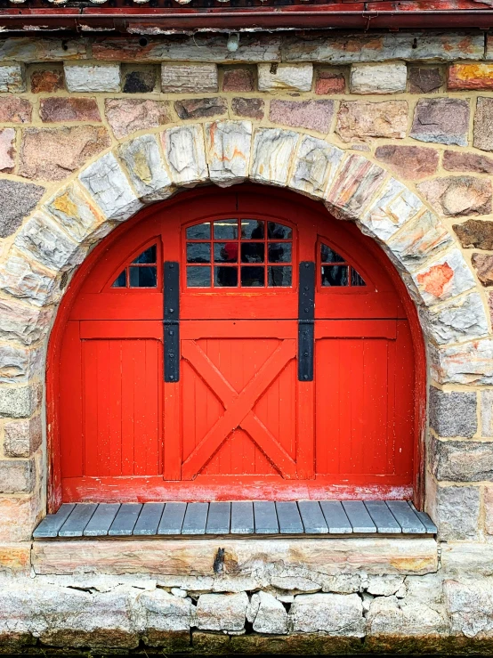 an image of an open red door on an arch