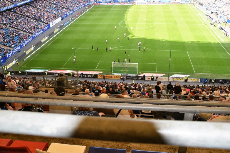 an empty soccer stadium filled with people watching a game