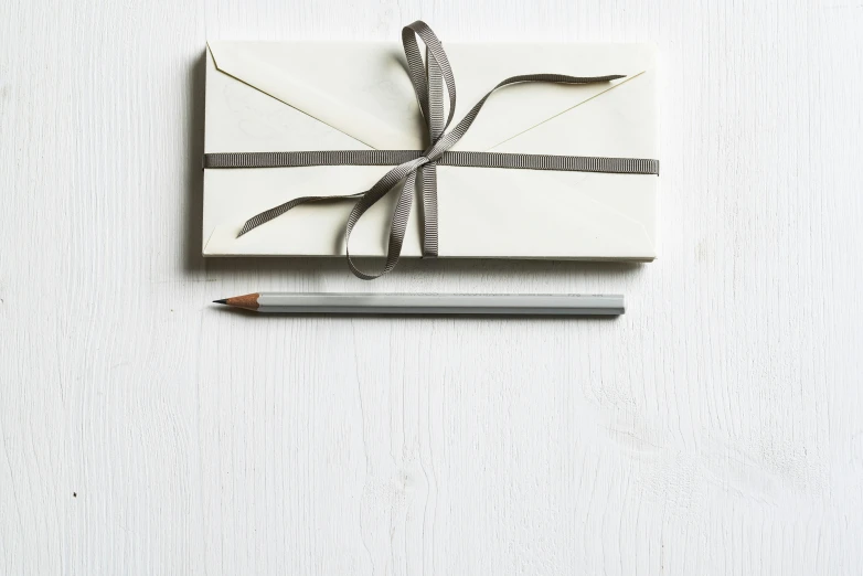 wrapped wrapped white paper with a brown ribbon