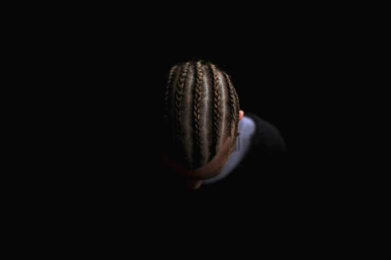 a man with dreadlocks looks up in the dark