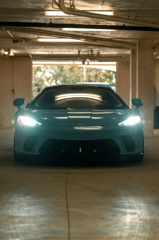 a blue sports car parked in an empty parking garage