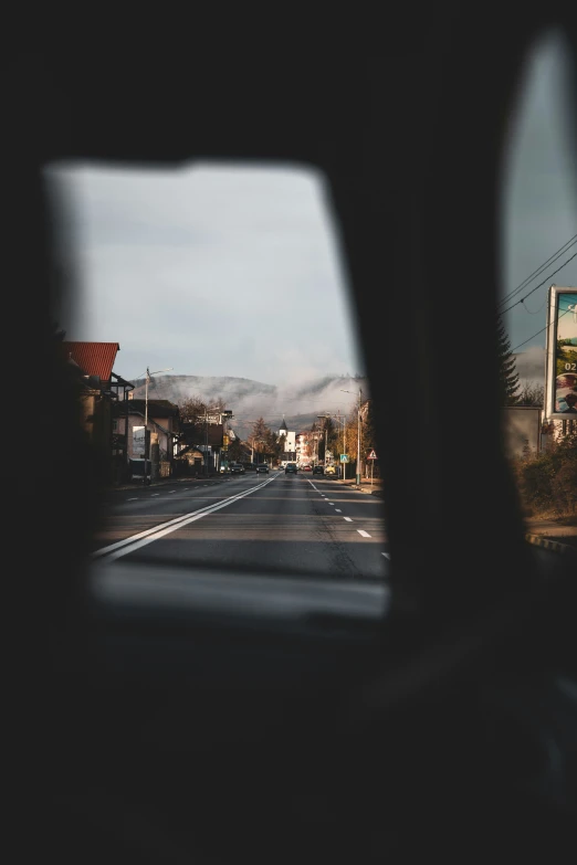 the view of a street from inside a car window