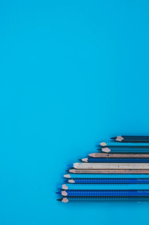 a group of blue pencils with one standing out