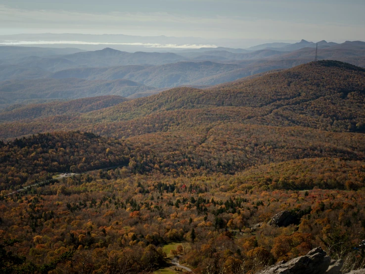 the view looking down at the mountains in autumn