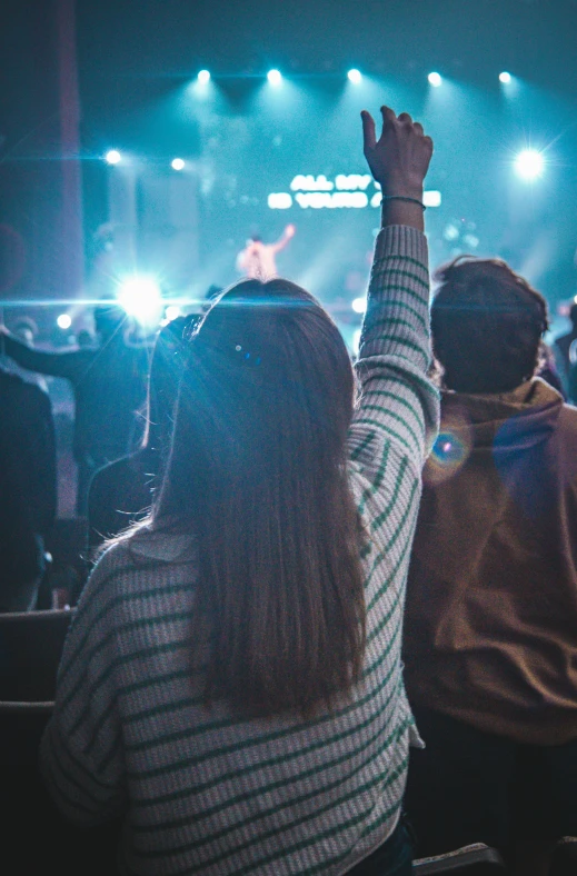 the person has their arms up to the music