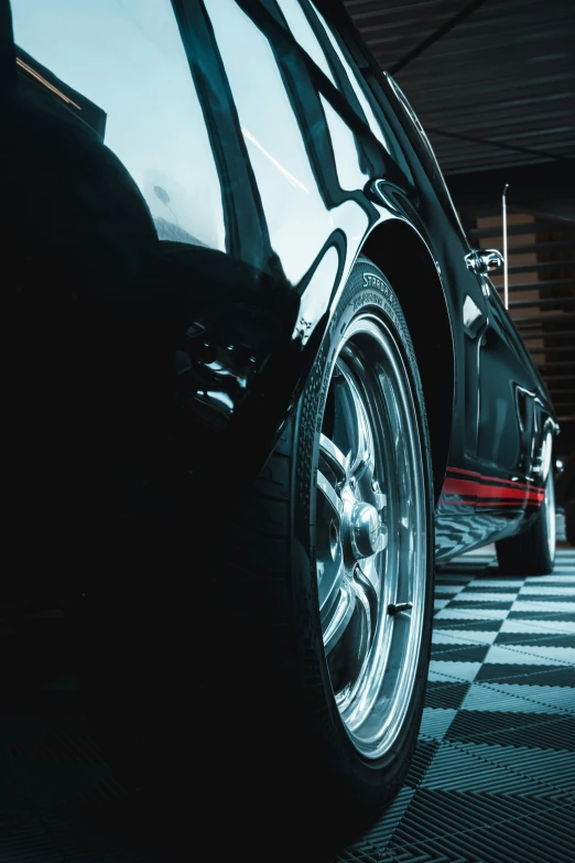 a dark car parked in a garage on the floor