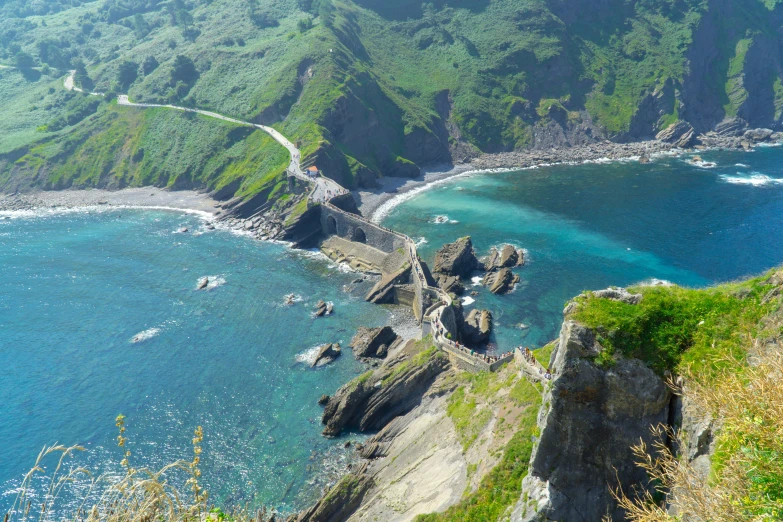 an aerial view of some blue water on top of a hill