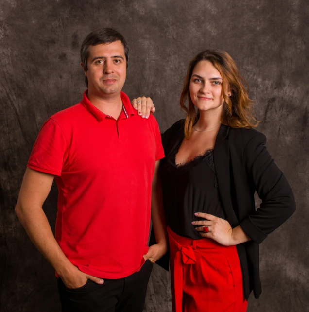 the woman is posed with a man wearing a red shirt