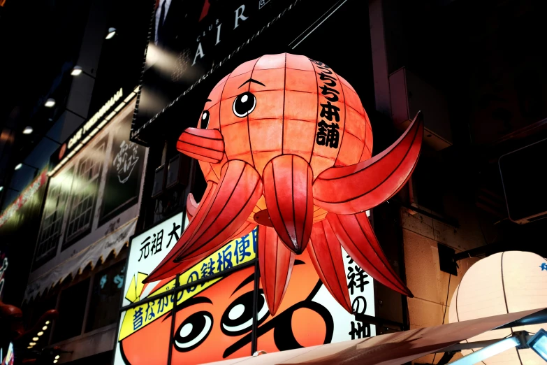 an octo with big eyes hanging from a building