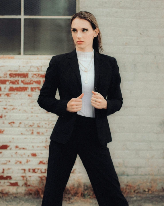 the model poses in her tuxedo