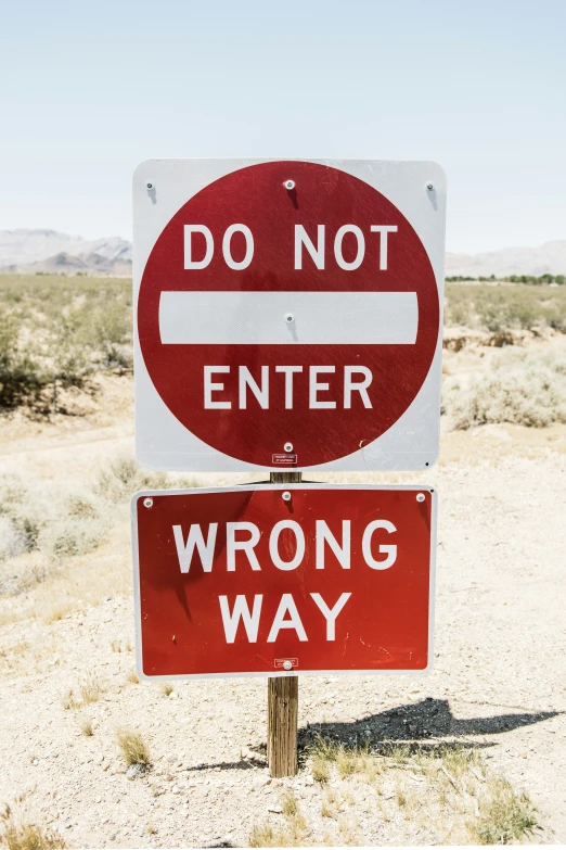 a do not enter sign sitting on the side of a road