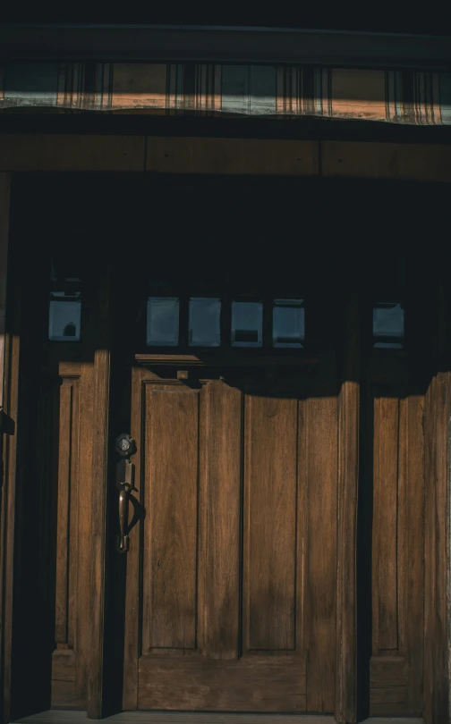 the door to an outside room with some wood