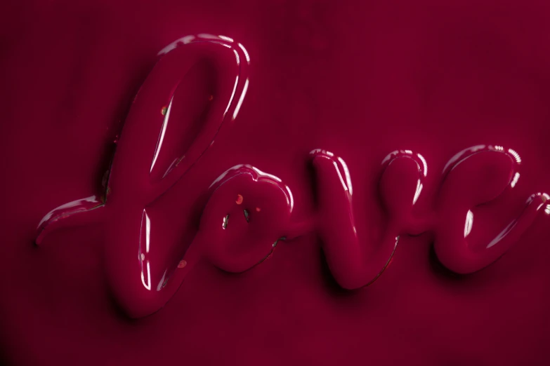 a sign made up of red melted paint on the word love