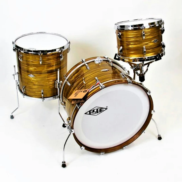two shiny drums sit upright next to each other