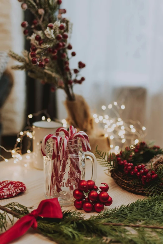 a candy cane decoration with berries and lights