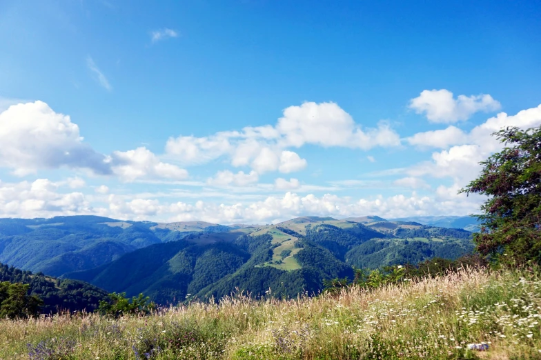 a view from the top of a high mountain overlooking a valley and hills