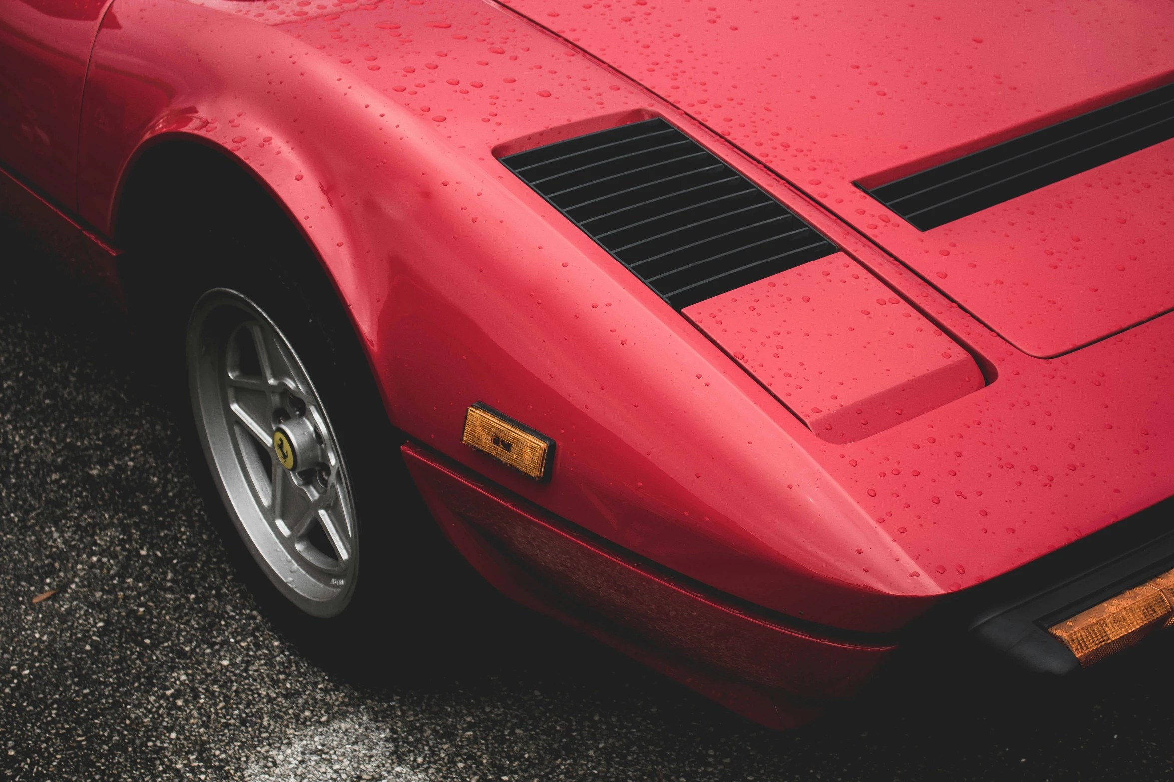 red sports car that is parked on the road