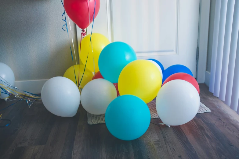 a bunch of balloons that are on a floor