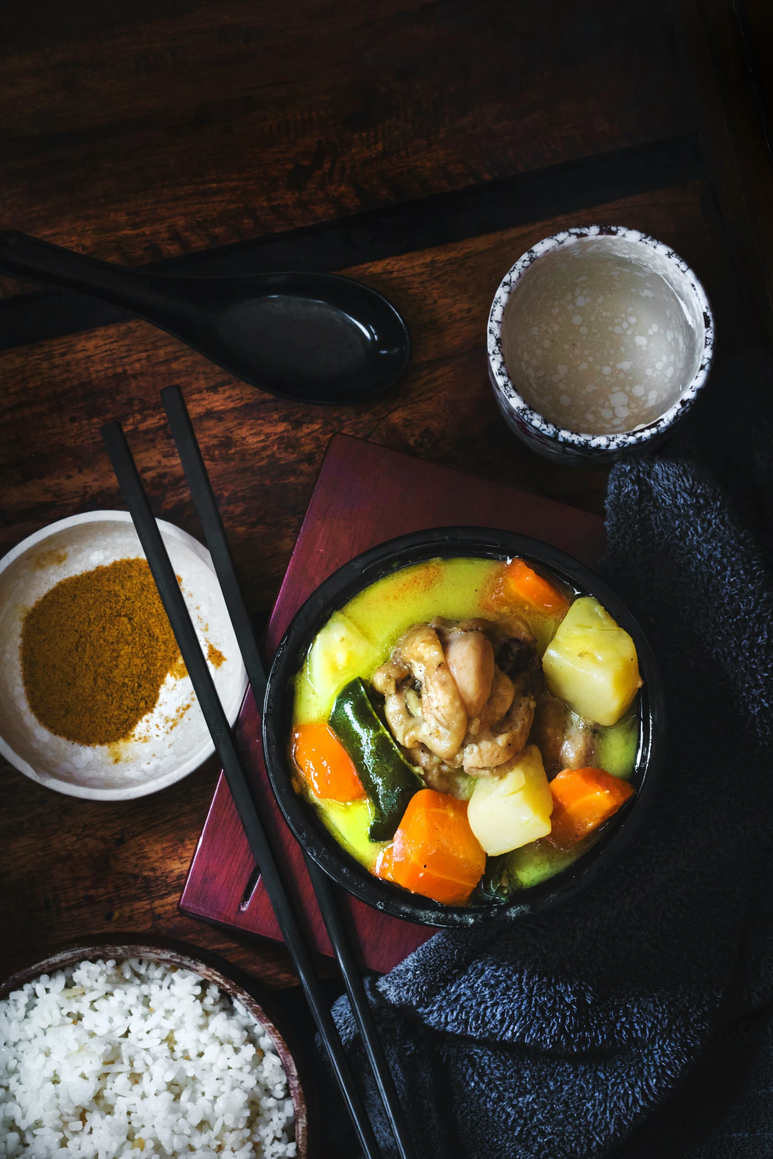 bowl of mixed vegetables with chopsticks sitting on table