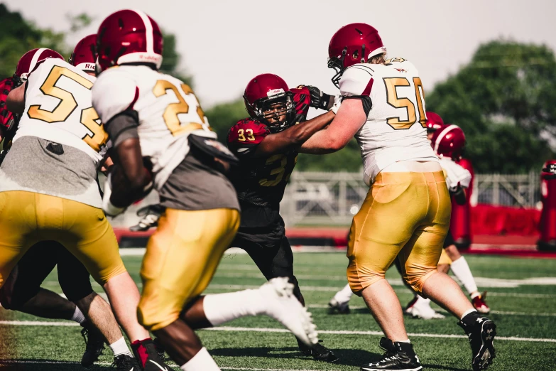 a football player holding onto his team on the field