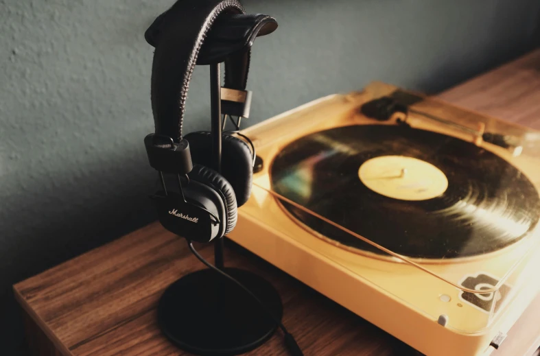 an old record player with headphones on it