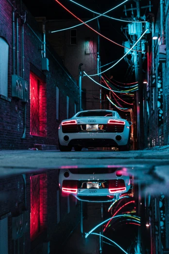 a sports car parked in a street with wires