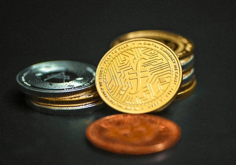 some coins are next to one another on a table