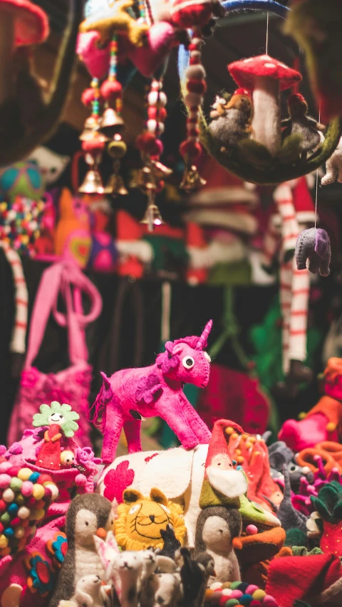 an assortment of colorful decorations hanging from a ceiling