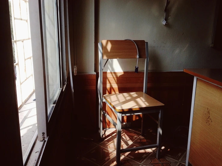 a chair is set next to a counter in the corner