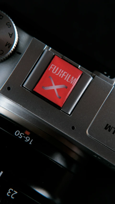 an analog clock with a red screen on top