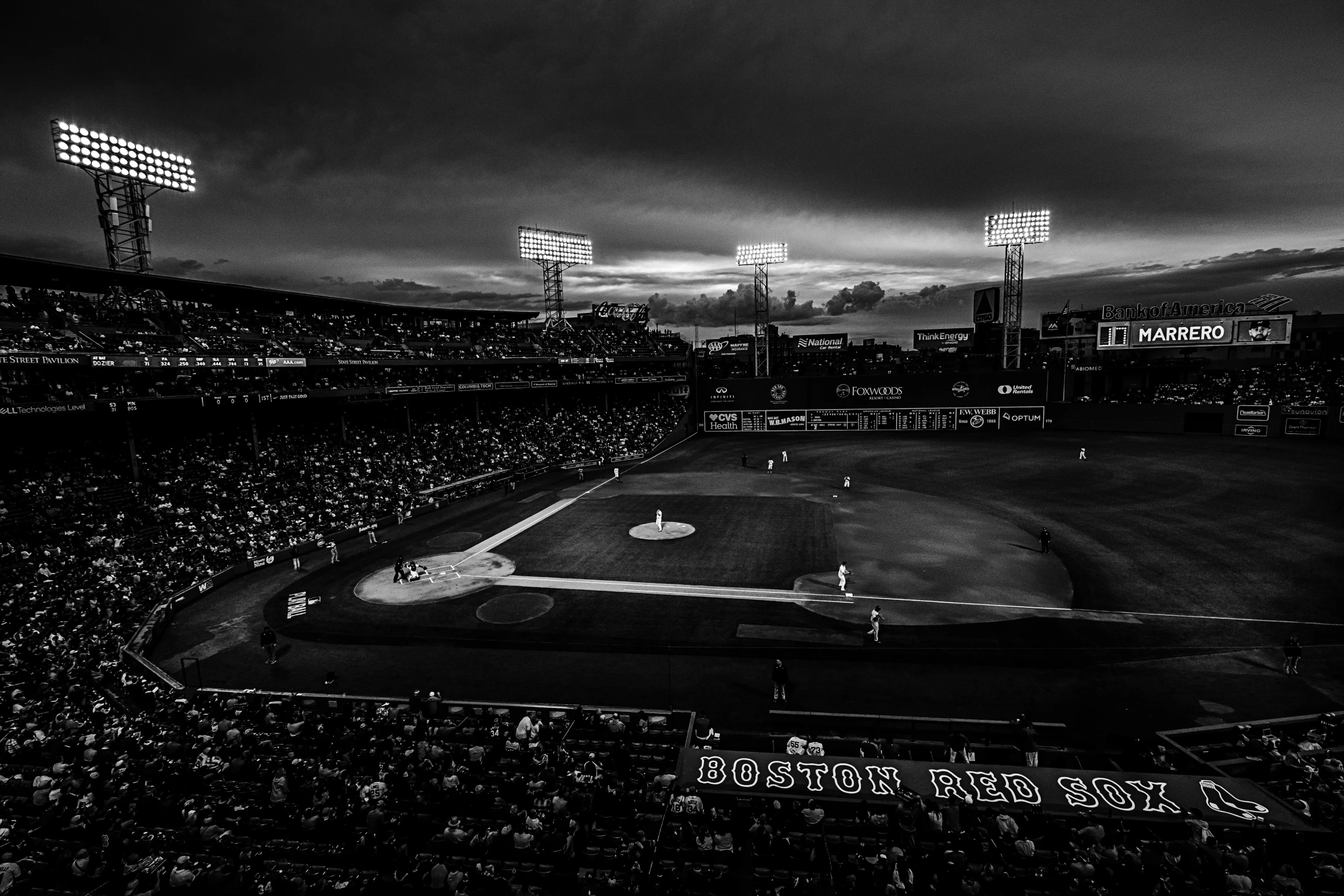 a baseball stadium with a lot of people and lights on the field