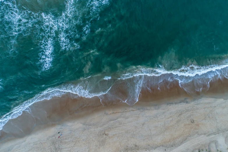 an aerial view shows the ocean and the sandy beach