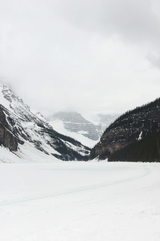 a snowboarder going down a snowy slope