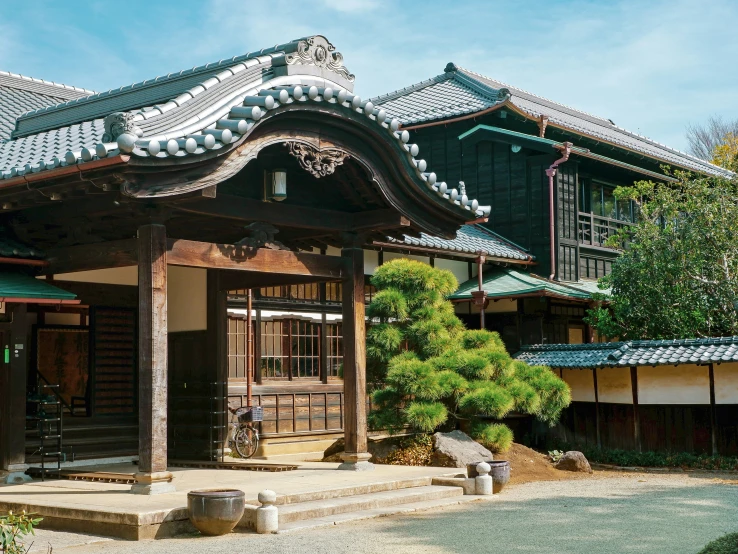 an old style building with a big lawn in front