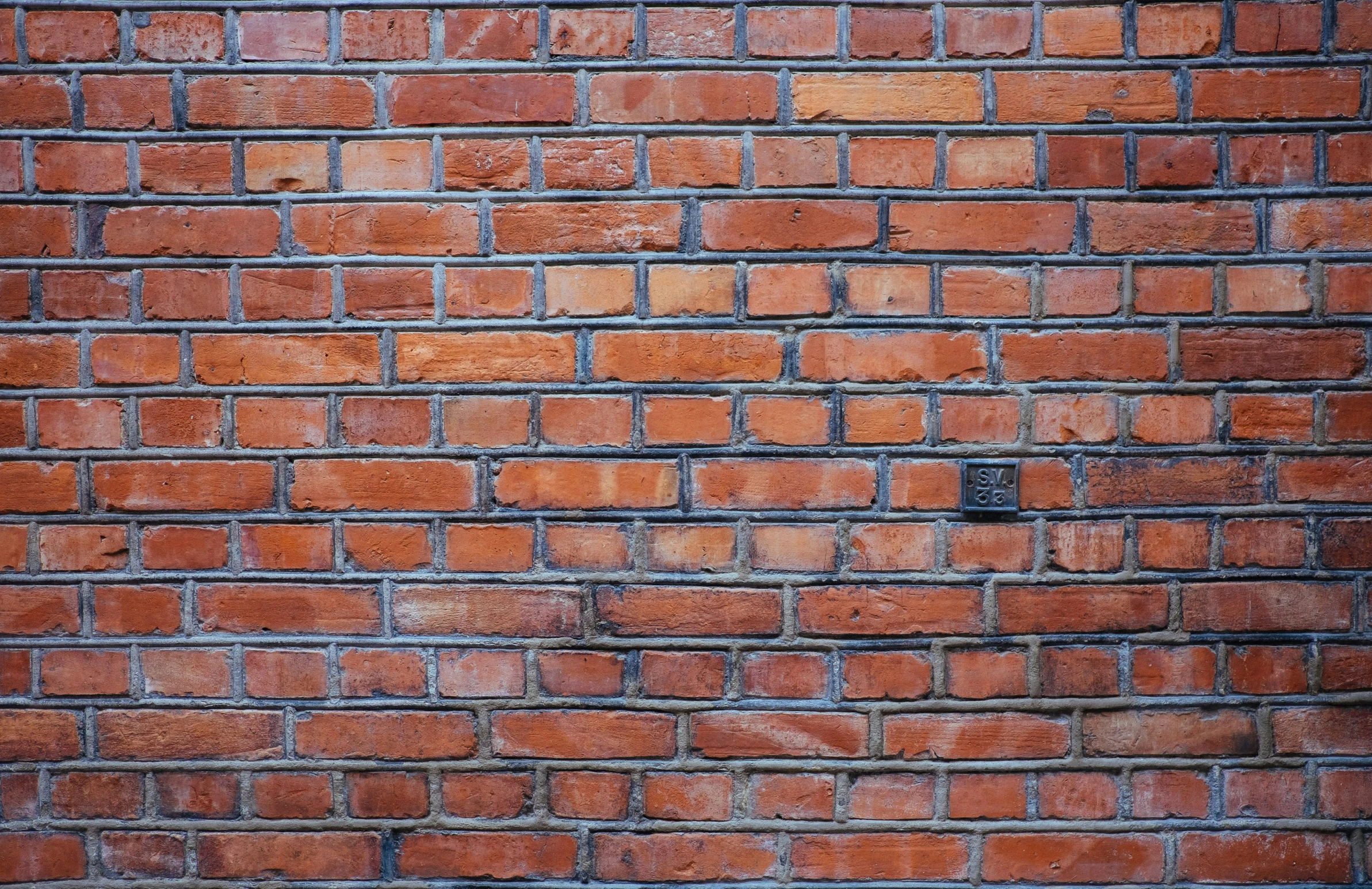 an orange brick wall with rough edges