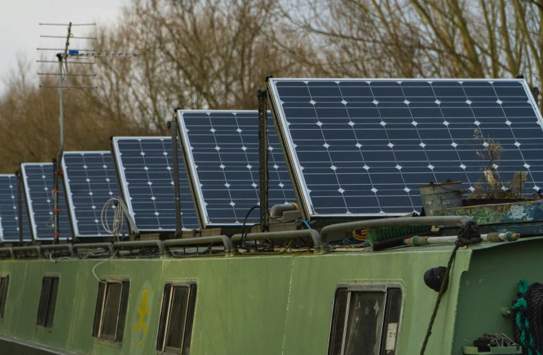 several small solar panels on top of an old vehicle