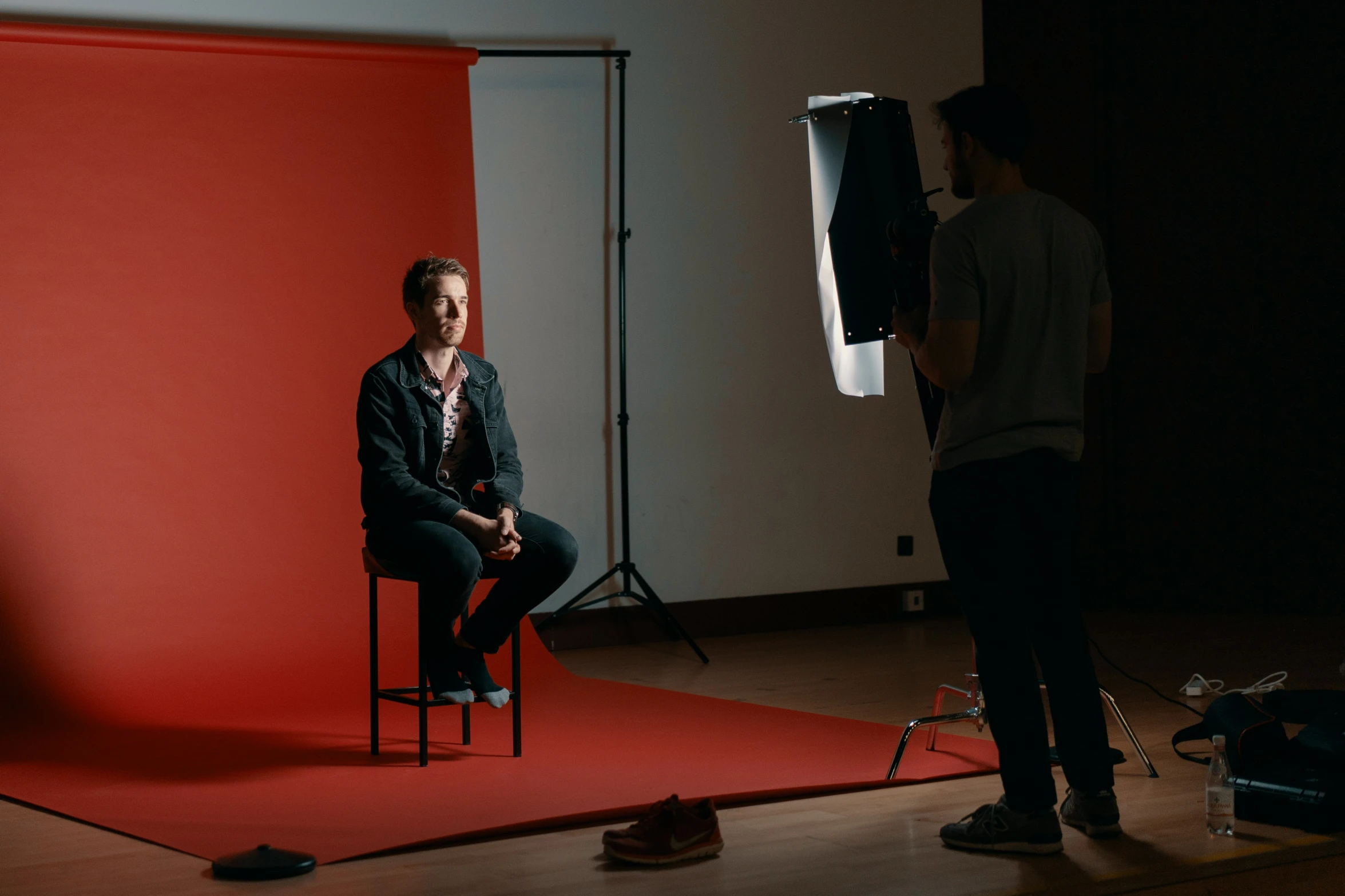 a man sitting in a chair in a studio