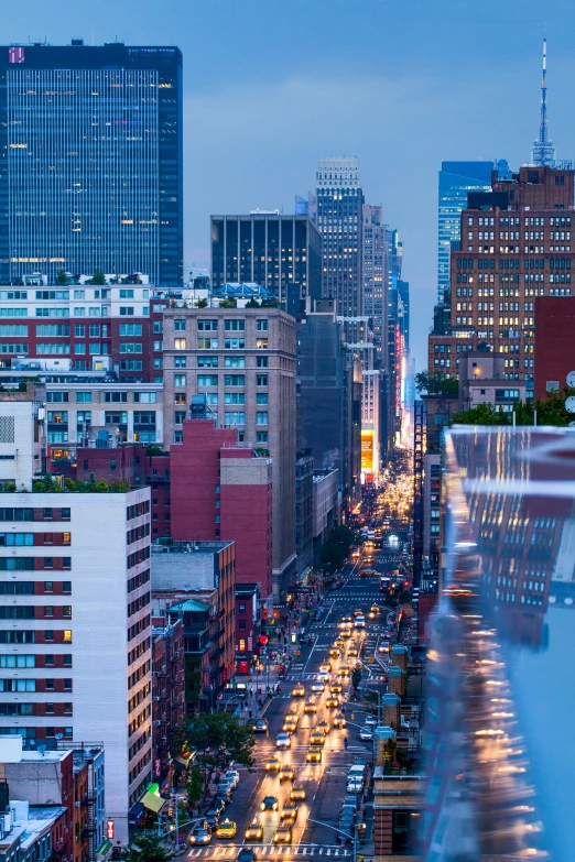 a city street filled with traffic next to tall buildings