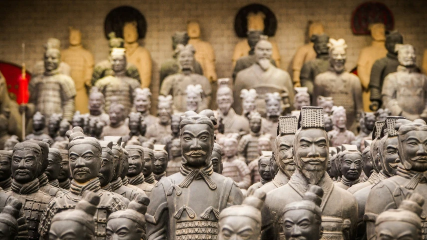 a large group of different sized sculptures and men