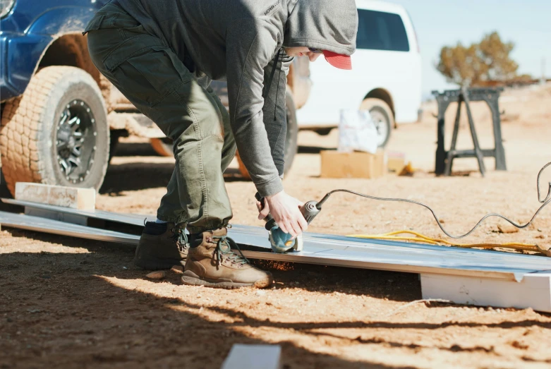 the man is working on soing outside in the dirt