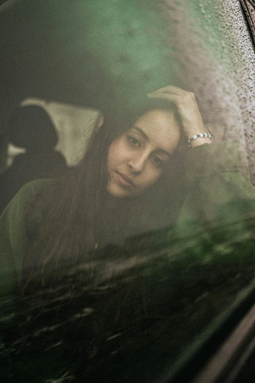 the reflection of a woman's head in a car mirror